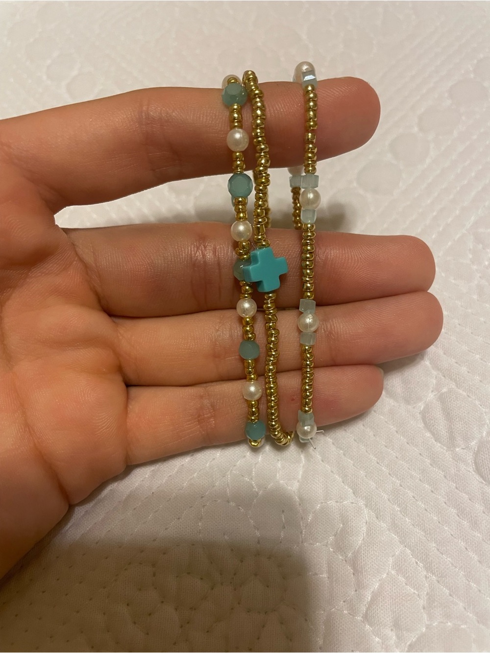 SET OF 3 gold, pearl, blue bracelets with a enewton cross.